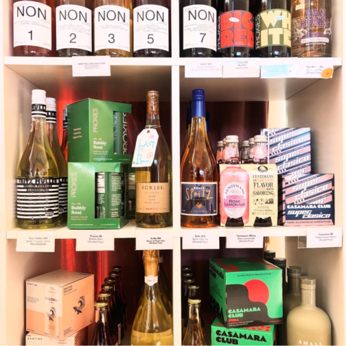 Shelves displaying alcohol-free beverages including NON wine alternatives, Proxies, Scribe, Bolle Spritz, Fentimans Rose Lemonade, and Casamara Club aperitivos at DECANT.