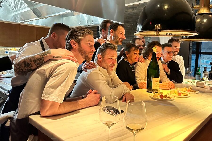 Jean-Marc Roulot, the Troisgros family, Daniel Johannes, and the team at the chef's table during the 2023 La Paulée dinner at Legacy Records.